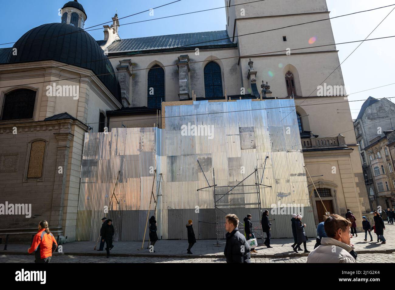 LVIV, UKRAINE - March 20, 2022:In order to protect them from damage, sculptures of the Saints of the Latin Cathedral are wrapped, and stained glass wi Stock Photo