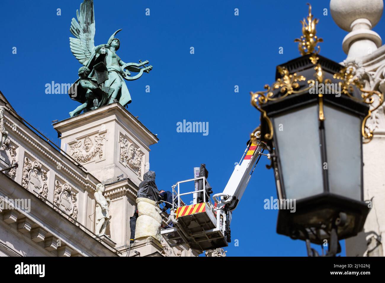 LVIV, UKRAINE - March 21, 2022: To protect the sculptures on the facade of the Lviv National Opera from damage due to possible bombing, rescuers of th Stock Photo