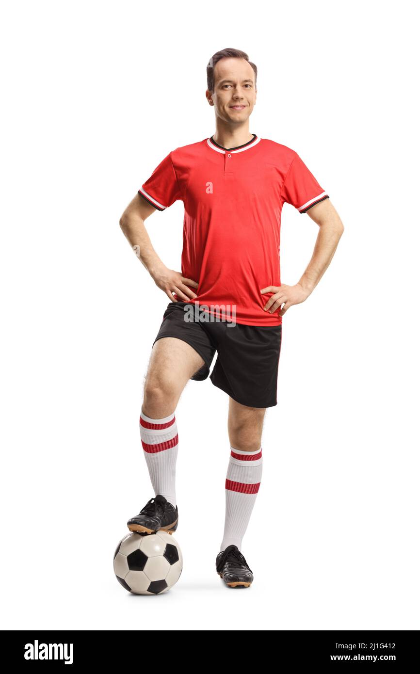 Man wearing football jersey and shorts and posing with a soccer ball  isolated on white background Stock Photo - Alamy