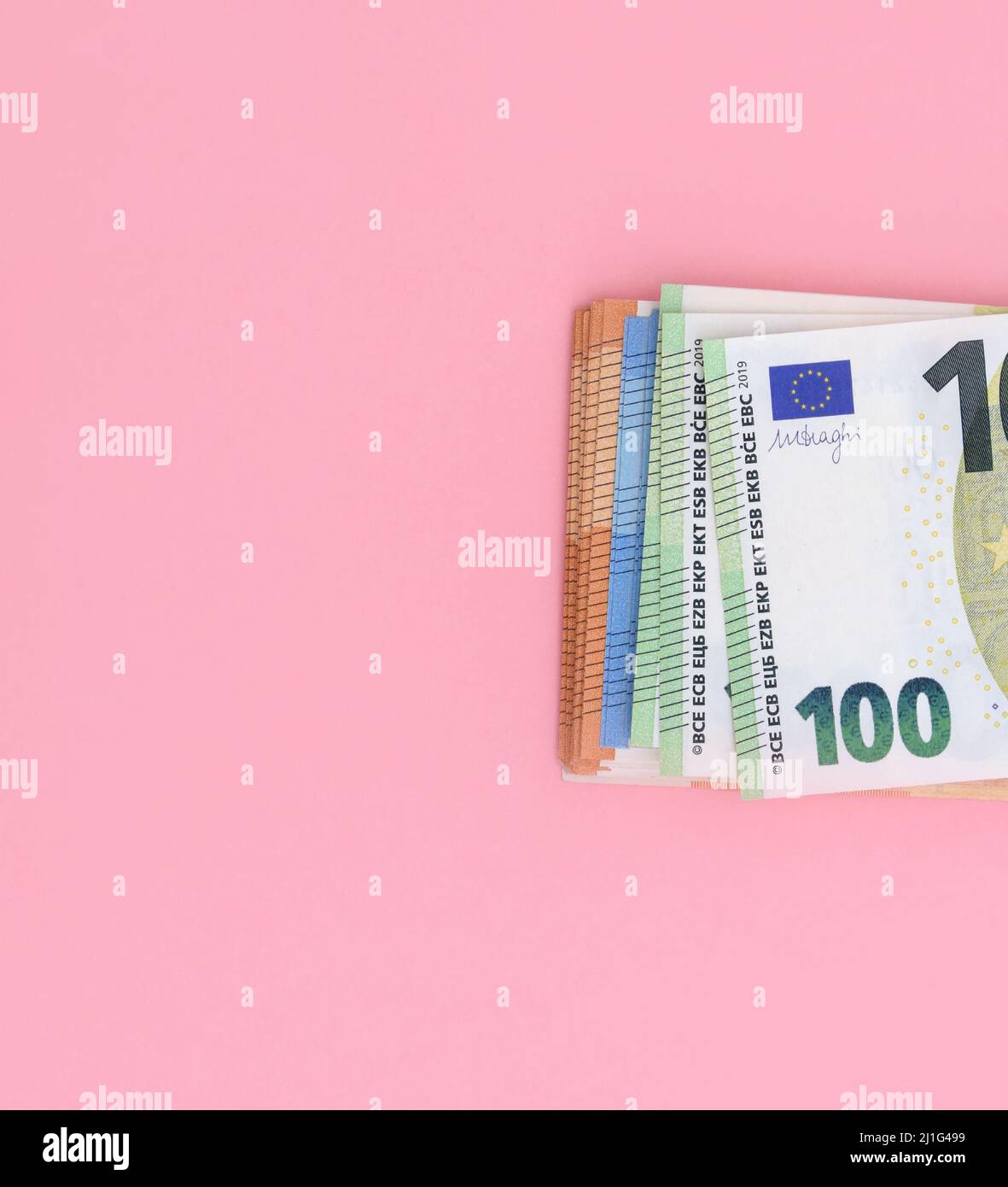 Pack of euro banknotes on pink background. European currency, business, finance Stock Photo