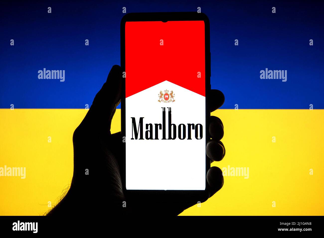 In this photo illustration a Marlboro logo seen displayed on a smartphone with a Ukrainian flag in the background. Stock Photo