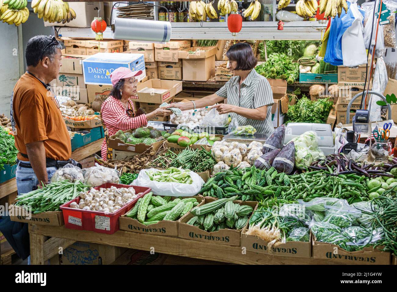 Honolulu Hawaii,Oahu,Hawaiian,Chinatown Kekaulike Street,produce covered market,Asian man woman female couple paying pays buying buys, Stock Photo