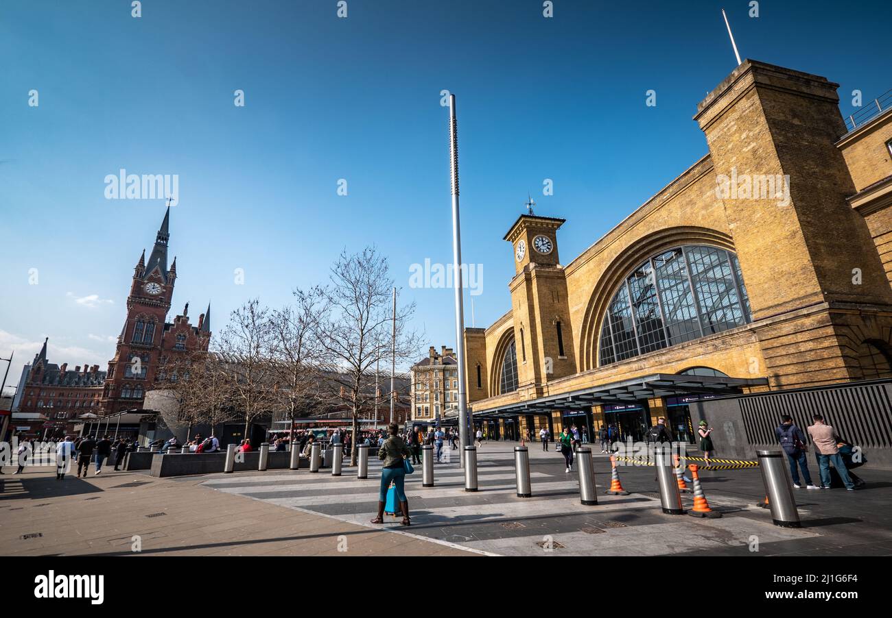 Kings Cross and St Pancras Railway Stations, London. Travellers and commuters milling outside the landmark train stations. Stock Photo