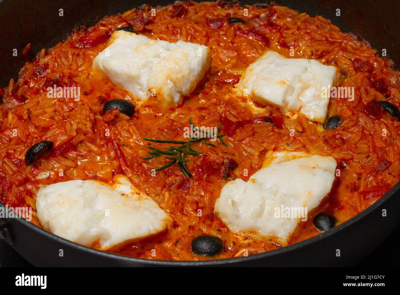 Baked cod with orzo and spicy sausage Stock Photo Alamy