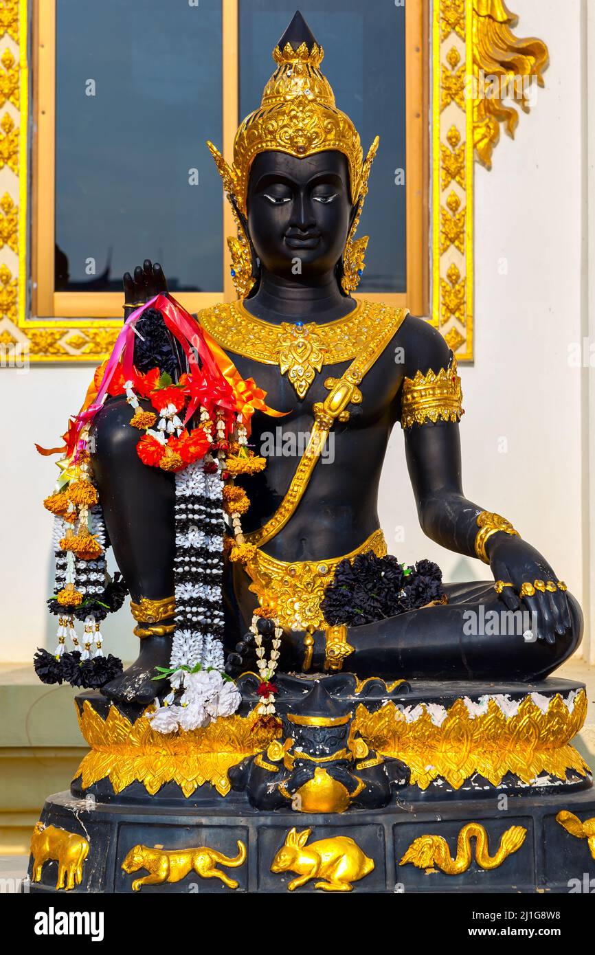a sitting black Buddha Statue at a Buddhist Temple in