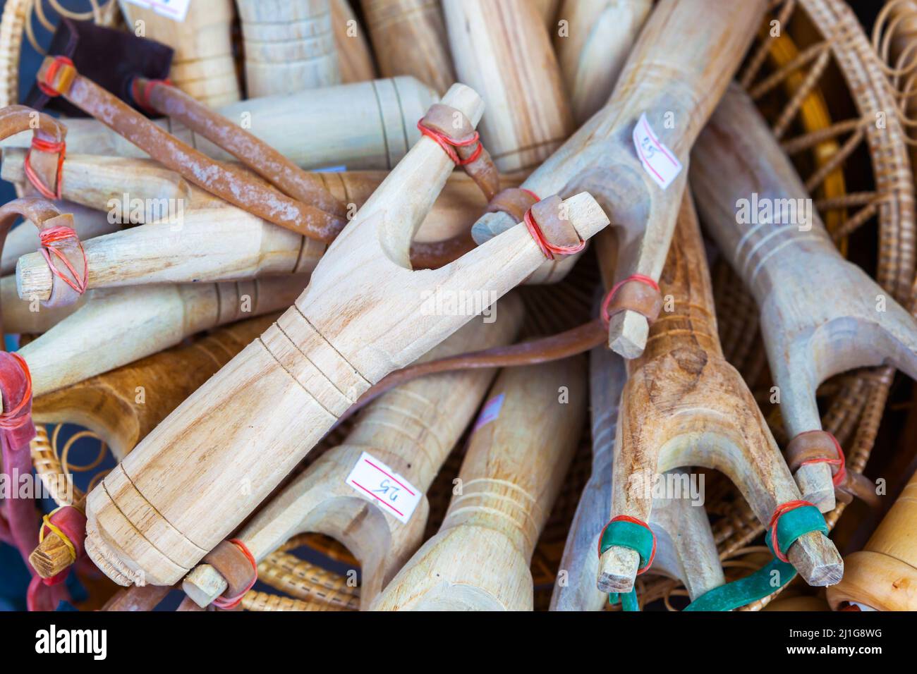 Wooden slingshots for sale at local market in Pattaya, Thailand Stock