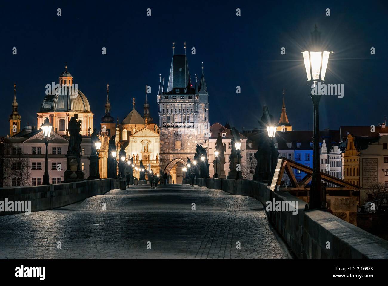 Prague, Czechia - 02.17.2022: View of Old Town Bridge Tower from Charles Bridge in the dark night. Prague center without people. Beautiful historical Stock Photo