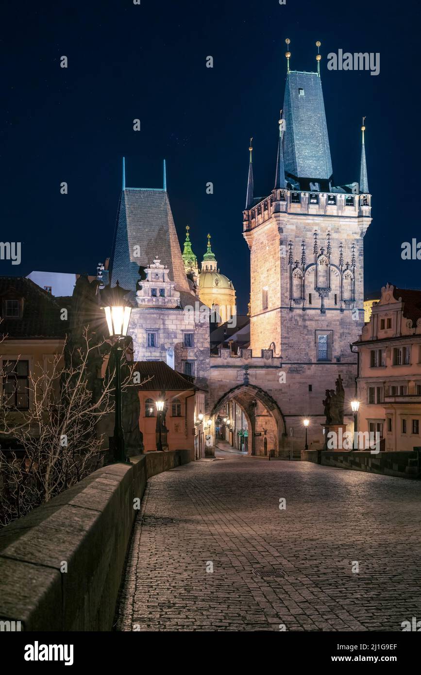 Prague, Czechia - 02.17.2022: View of Mala Strana Bridge Towers from Charles Bridge in the dark night. Prague center without people. Beautiful Stock Photo
