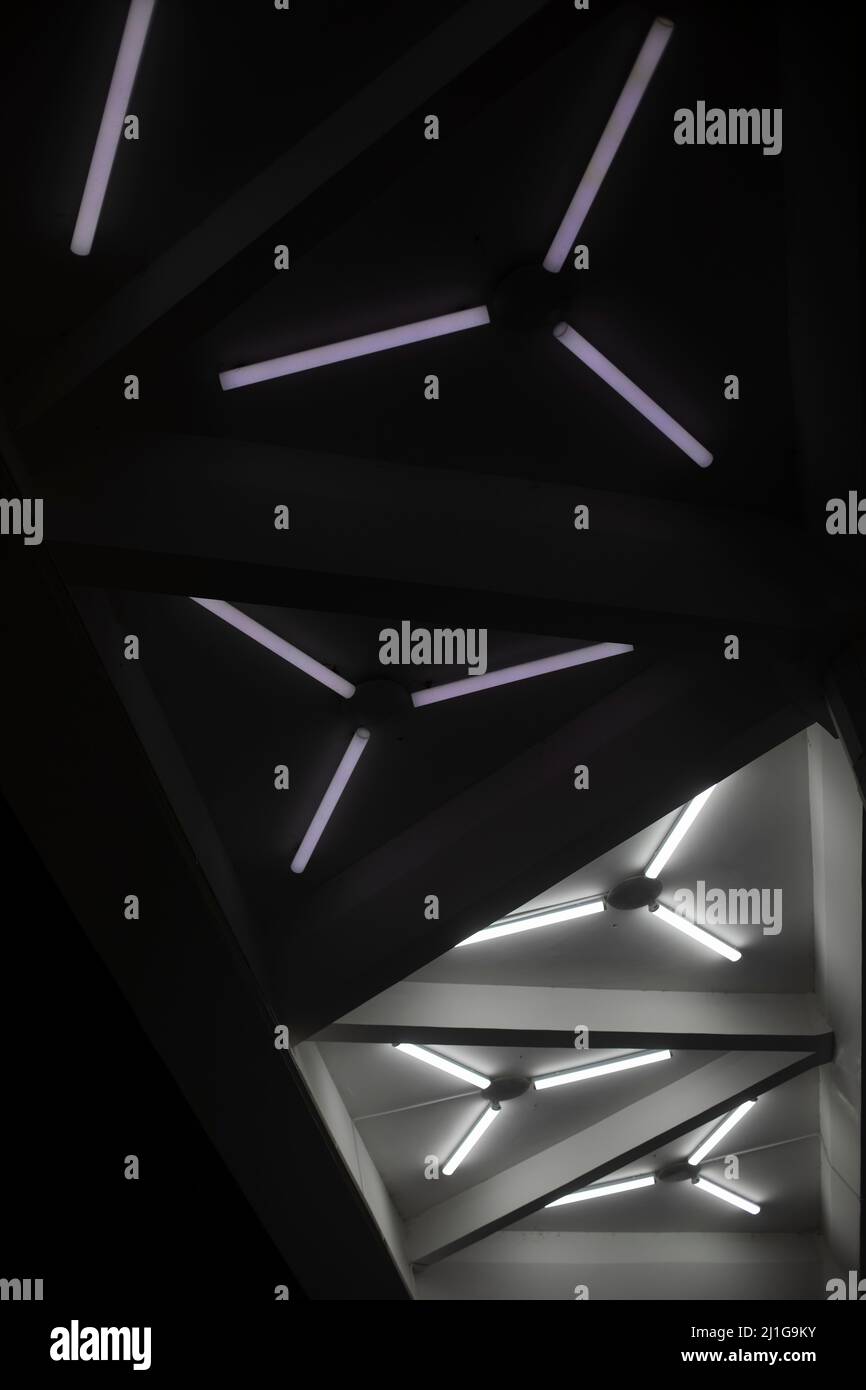 Light design. Fluorescent lamps on ceiling. Triangles of lamps