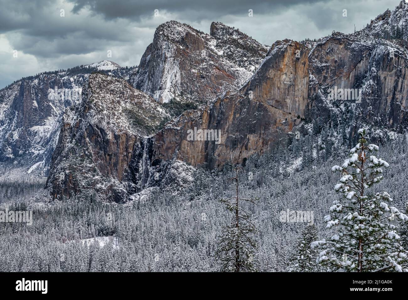 Yosemite Valley view in winter with Cathedral Spires and Bridalveil falls after a snow storm, Yosemite National Park Stock Photo