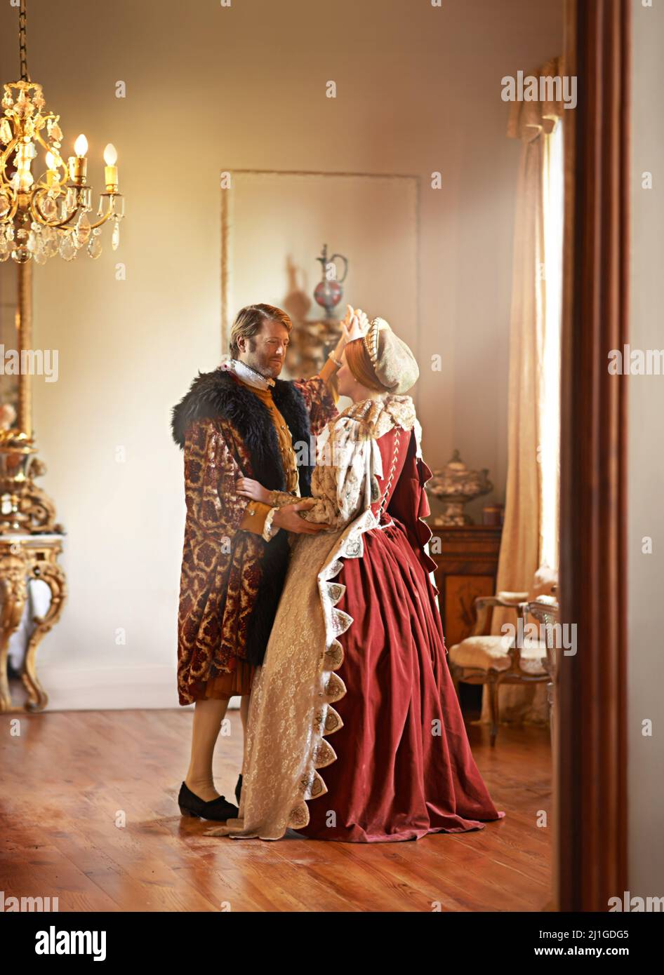 Sharing a tender moment. A king and queen dancing together in their palace. Stock Photo