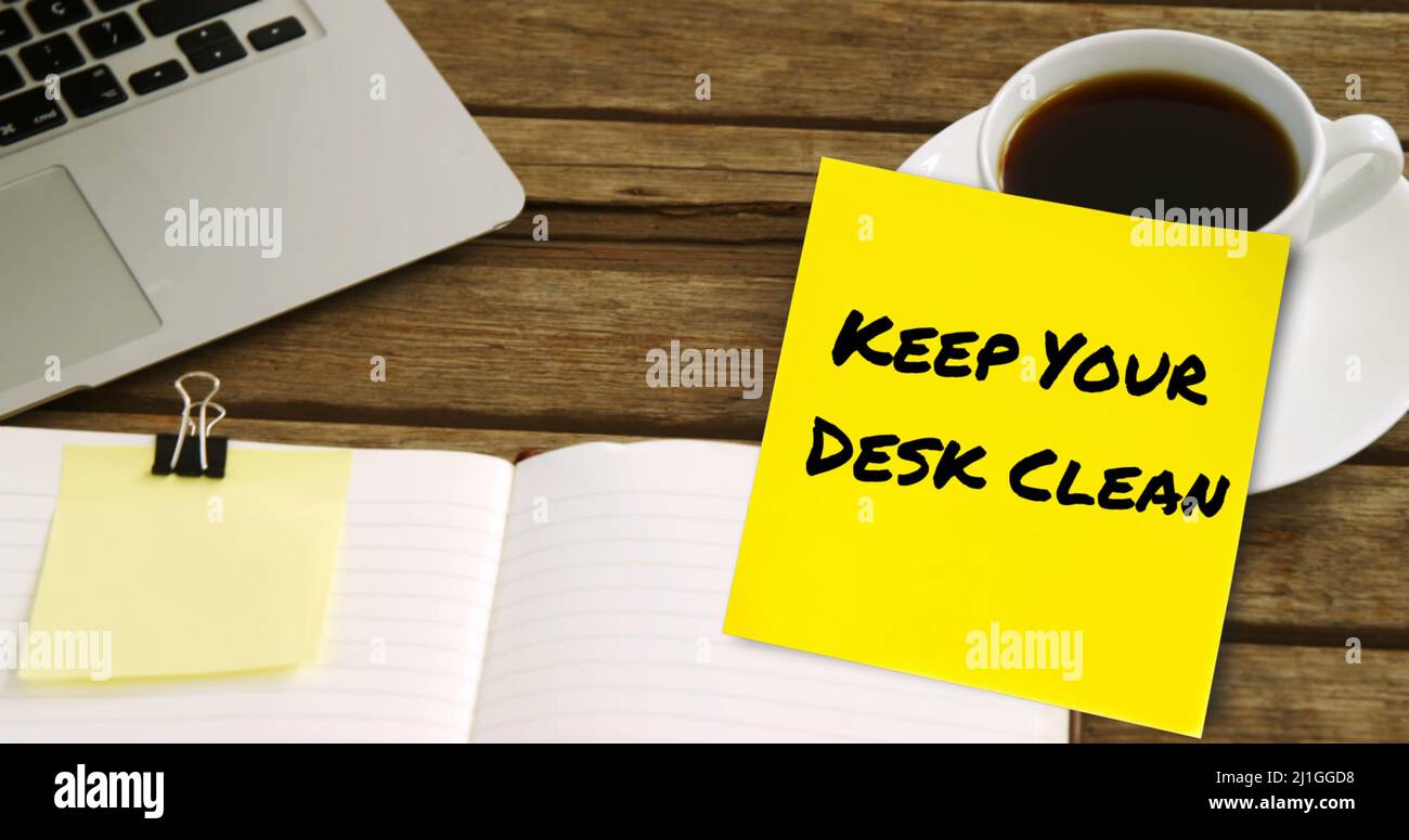Image of keep your desk clean text on yellow memo note on desk with ...