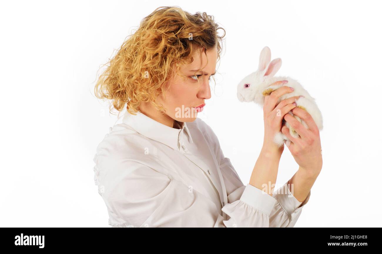 Beautiful girl with white baby rabbit. Friendship with Easter Bunny. Stock Photo