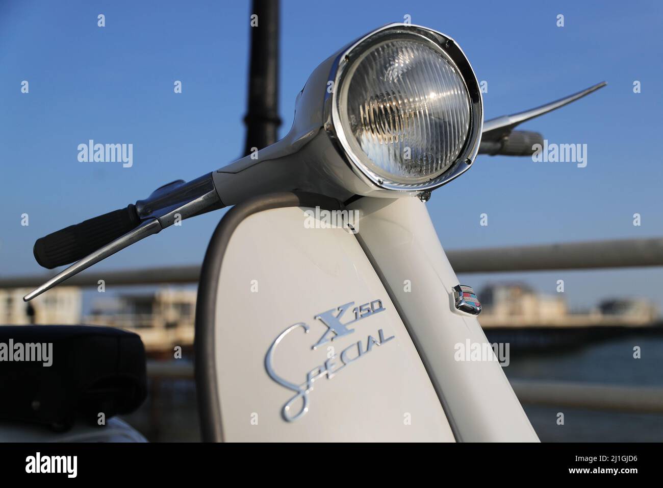Italian Innocenti Lambretta SX150 motor scooter, photographed on Worthing seafront, the pier, The Dome, fishing boat Stock Photo