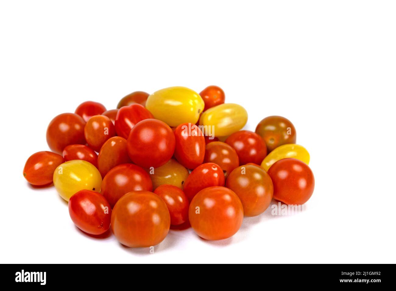 Various mini tomatoes against a white background Stock Photo