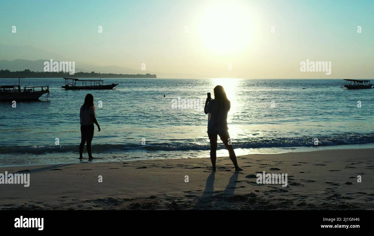 A young girls walk along the beach in the evening while relaxing at a