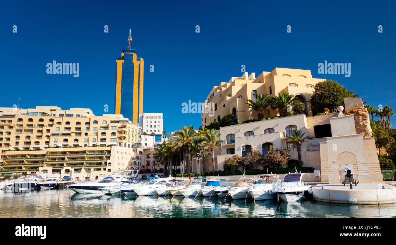 Fantastic city landscape on the seaside with boats. Portomaso Business Tower, Malta. Stock Photo