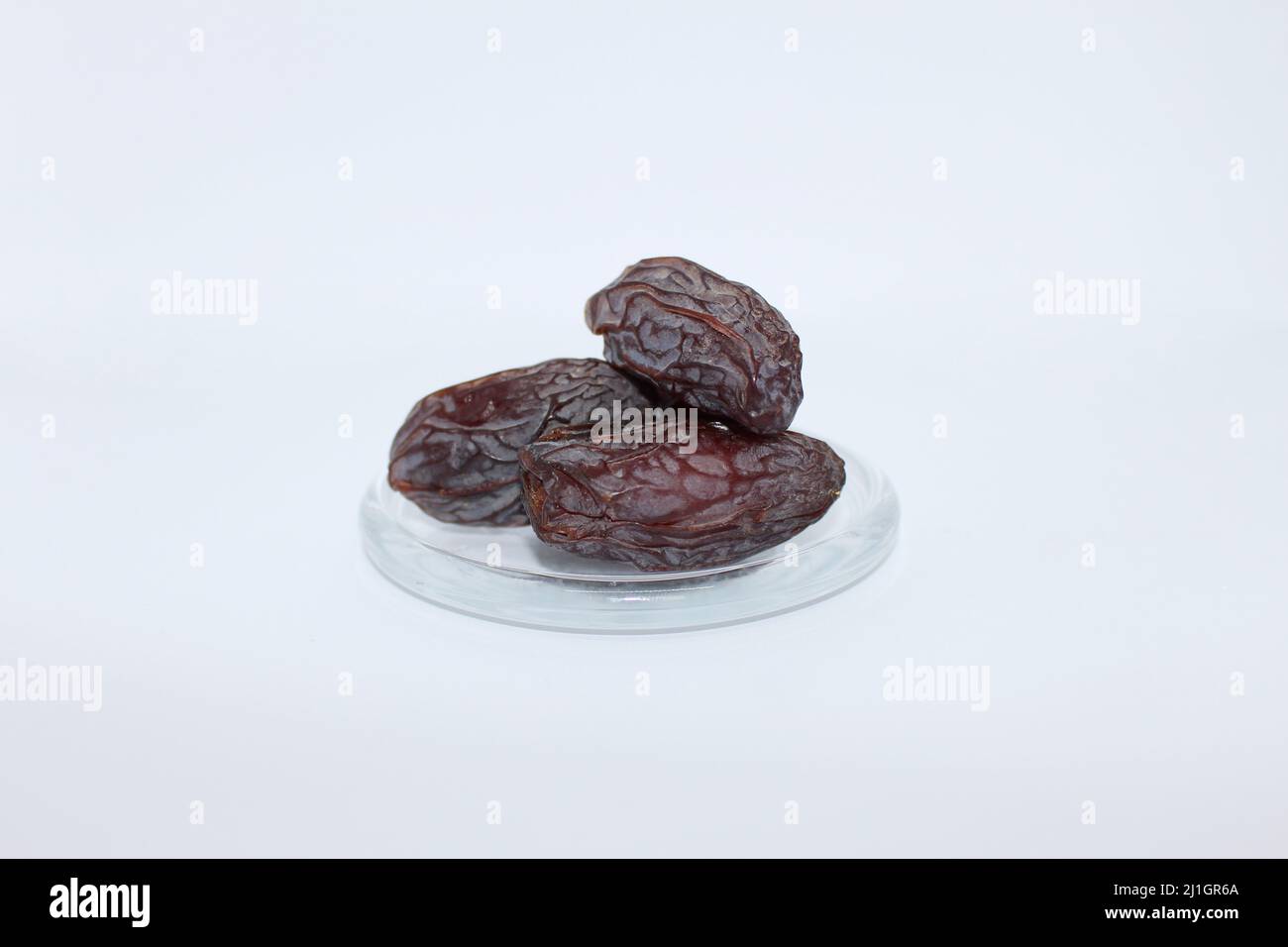 Fresh dried dates Medjool, close-up isolated on white background. Stock Photo