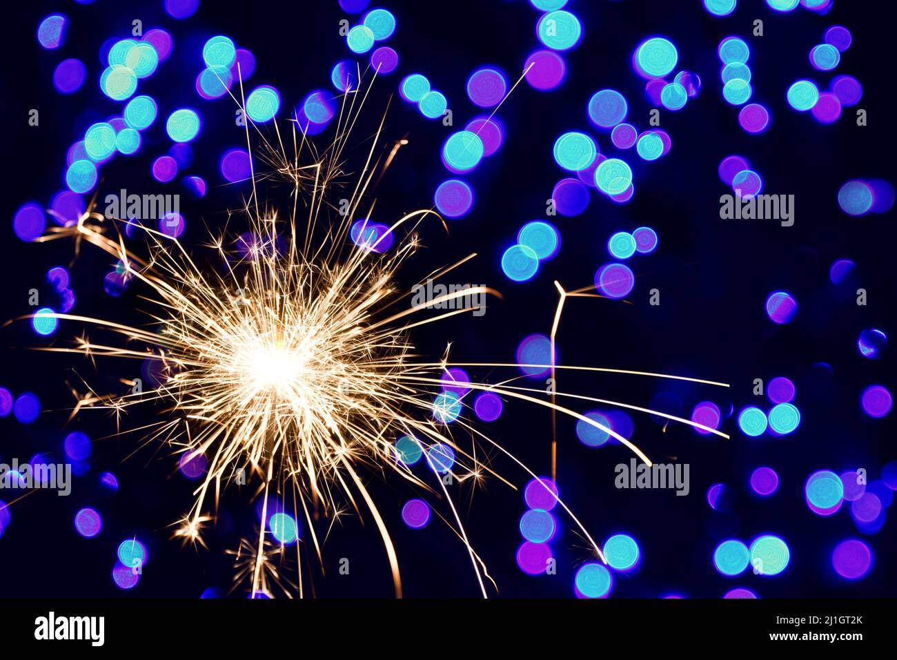 Christmas sparklers and background with colorful bokeh Stock Photo - Alamy