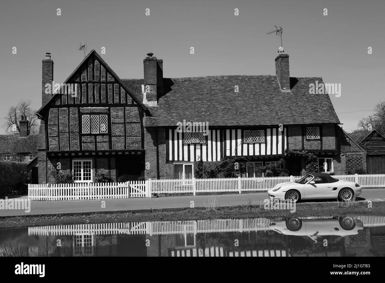 Pond & The Old Manor House with parked yellow Sportscar, Aldbury
