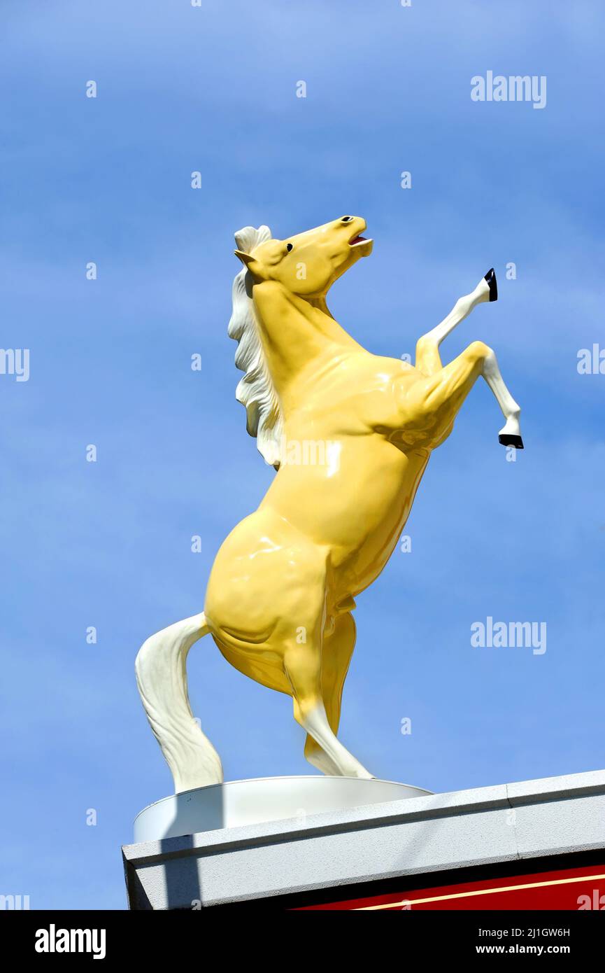 Statue of a wild stallion rearing its legs into the air, is sillouetted against a blue sky in Montana.  Wild west symbol. Stock Photo