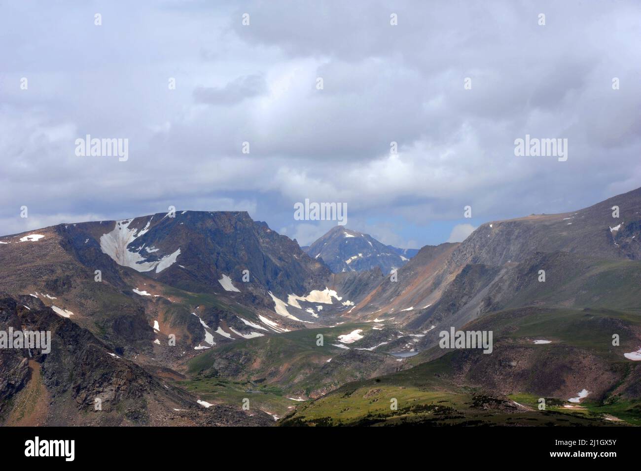 Rugged mountains and snow encrusted peaks, are part of the scenery on Beartooth Pass, in Wyoming. Stock Photo