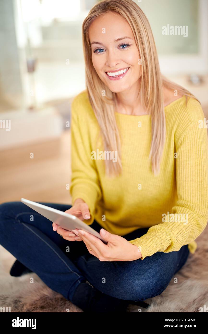 Shes the epitome of home comfort. A beautiful young woman sitting ...