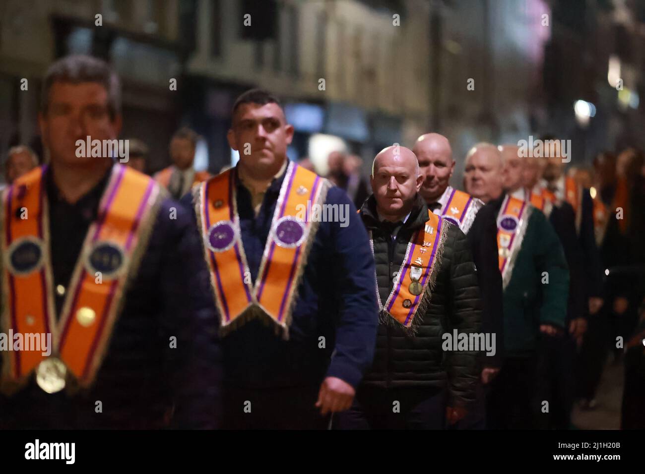 Orange men march during an anti Northern Ireland Protocol rally and parade, organised by North Antrim Amalgamated Orange Committee, in Ballymoney, Co Antrim. Picture date: Friday March 25, 2022. Stock Photo