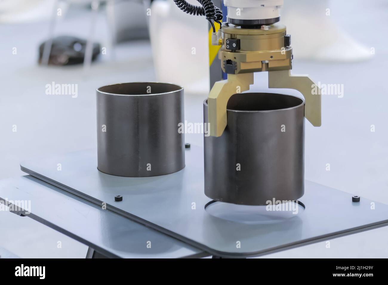 Pick and place robotic arm manipulator moving cylindrical metal workpiece Stock Photo Alamy