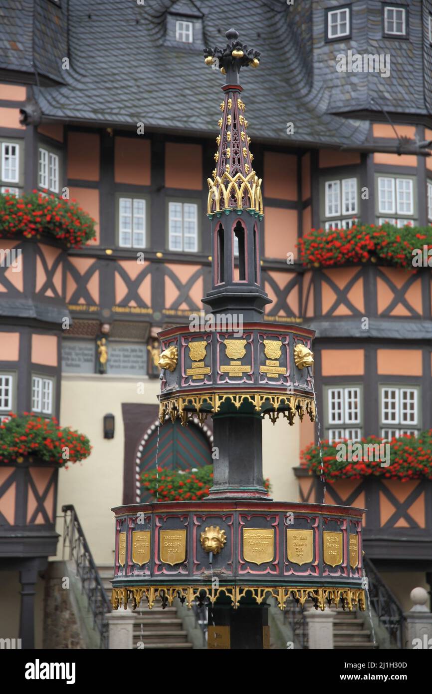 Benefactor fountain on the market square in front of the town hall in Wernigerode, Saxony-Anhalt, Germany Stock Photo