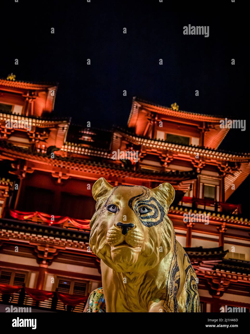 A golden tiger statue in the background of Buddha Tooth Relic Temple