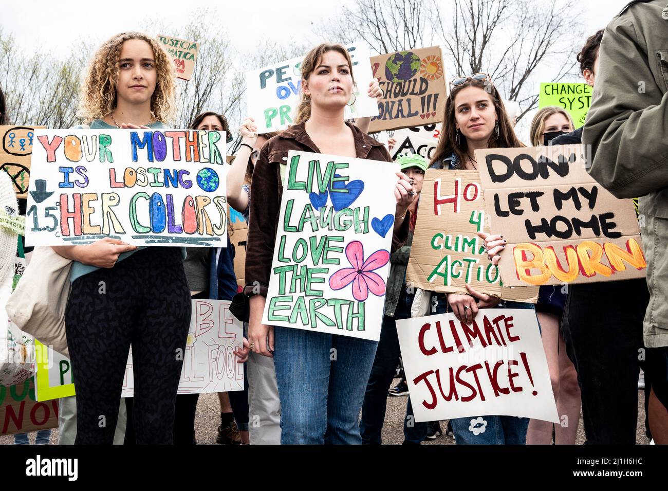 Washington, United States. 25th Mar, 2022. March 25, 2022 - Washington, DC, United States: Women holding signs saying 'Your mother is losing her colors', 'Live laugh love the earth' and 'Don't burn my home' at a Global Climate Strike demonstration. (Photo by Michael Brochstein/Sipa USA) Credit: Sipa USA/Alamy Live News Stock Photo