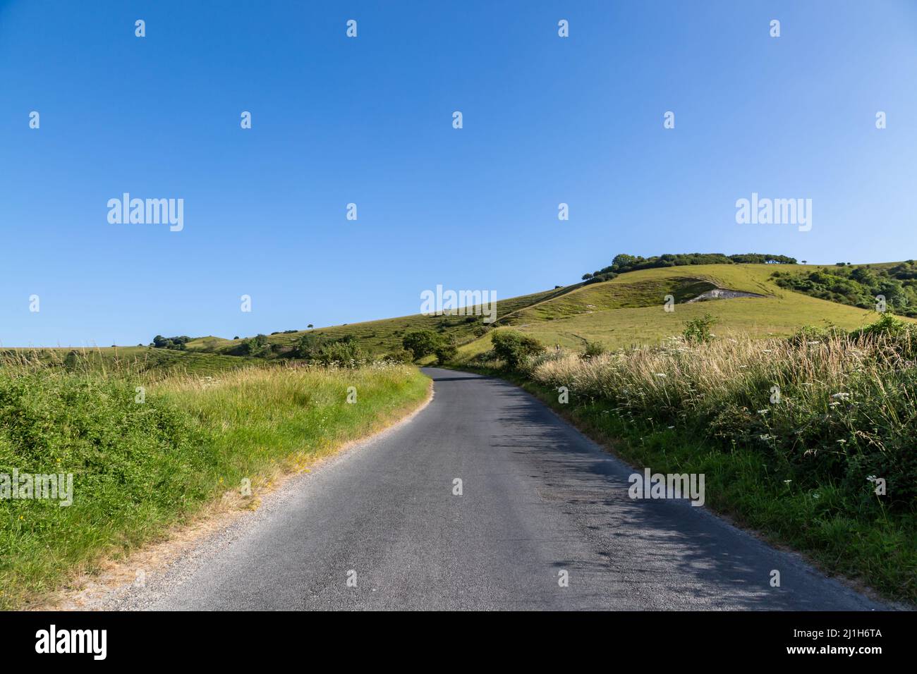 Looking along a country road in Sussex, on a sunny summers day Stock Photo