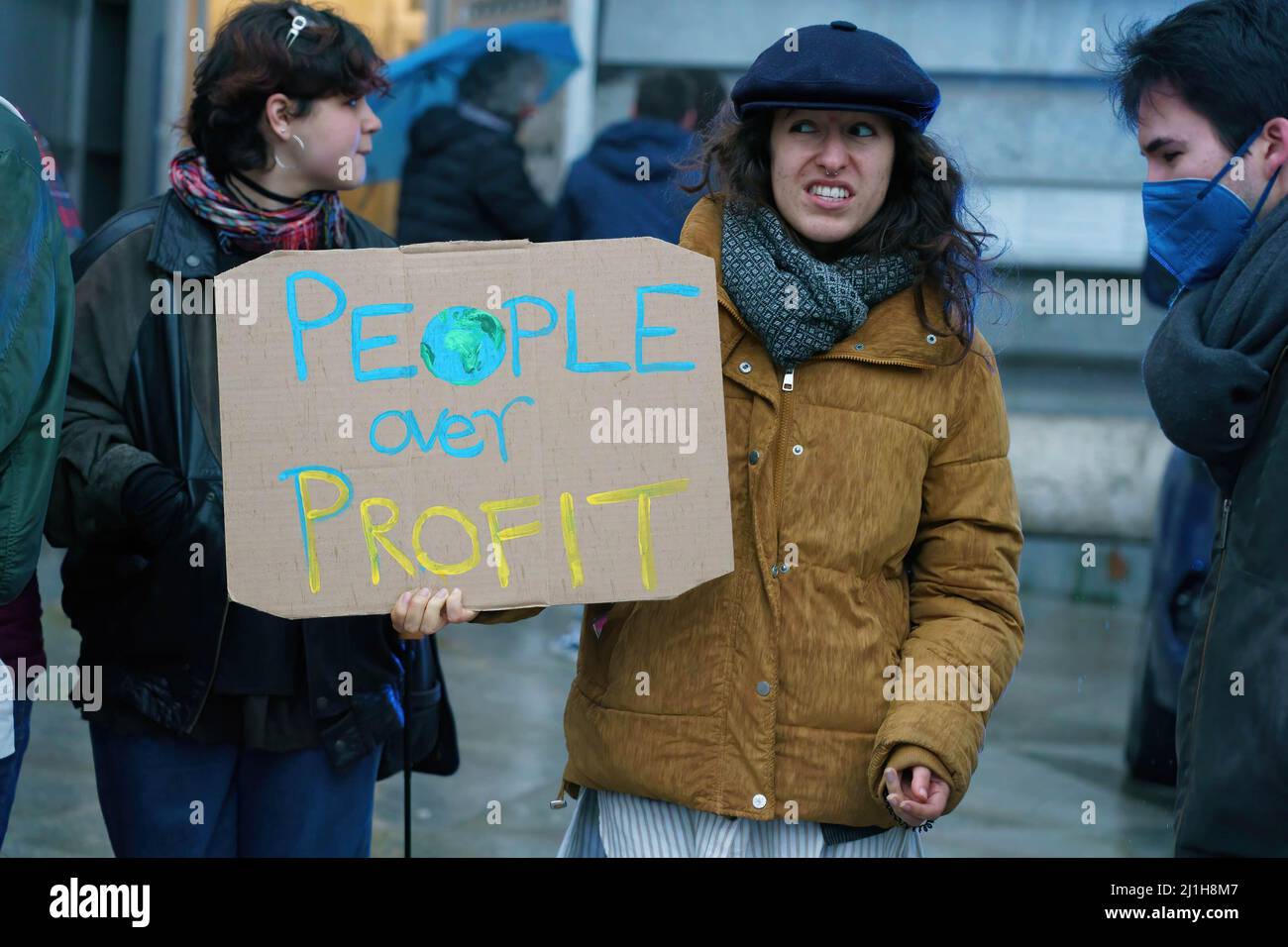 Madrid, Spain. 25th Mar, 2022. A protester holds a placard saying people over profit during the demonstration. Youth for Climate, representing the international movement Fridays For Future, mobilized a demonstration on World Climate Day to demand that the law on Climate Change should be 'adapted to the current reality'. Credit: SOPA Images Limited/Alamy Live News Stock Photo