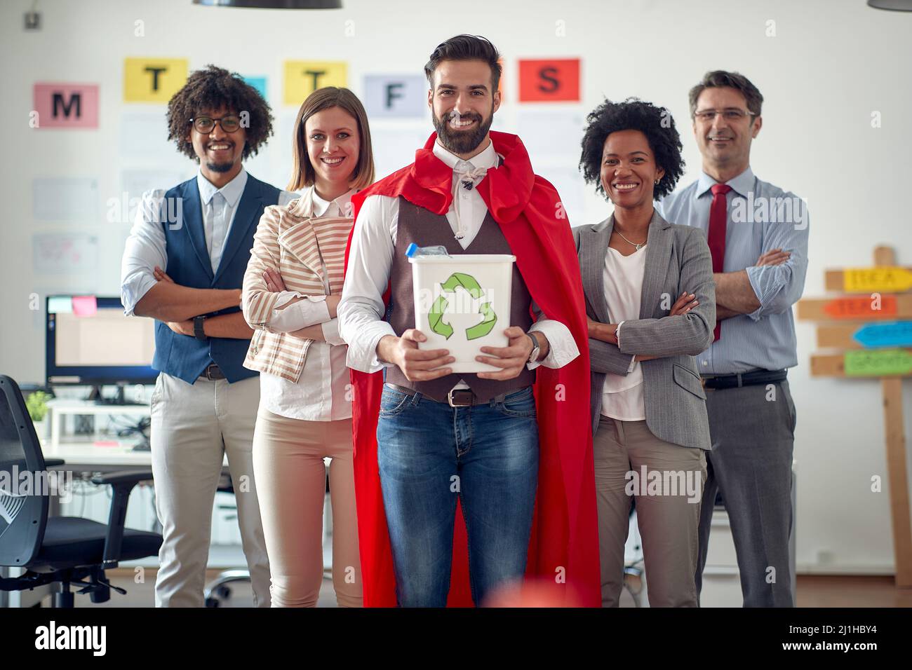 Group of environmentally focused employees recycling together in the ...