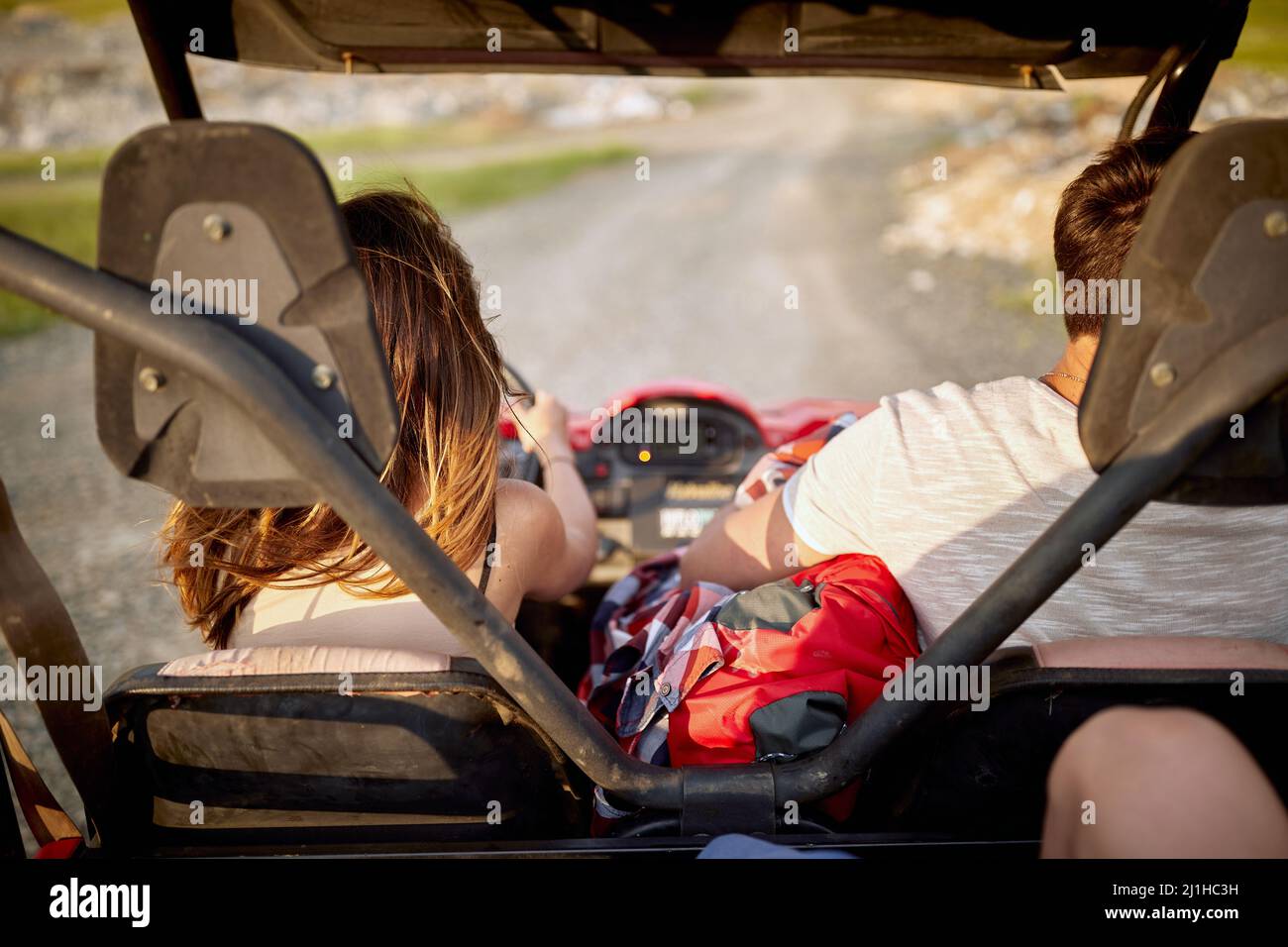 Young friends on an off road adventure, summertime, mountain landscape. Freedom, friendship, nature concept. Stock Photo
