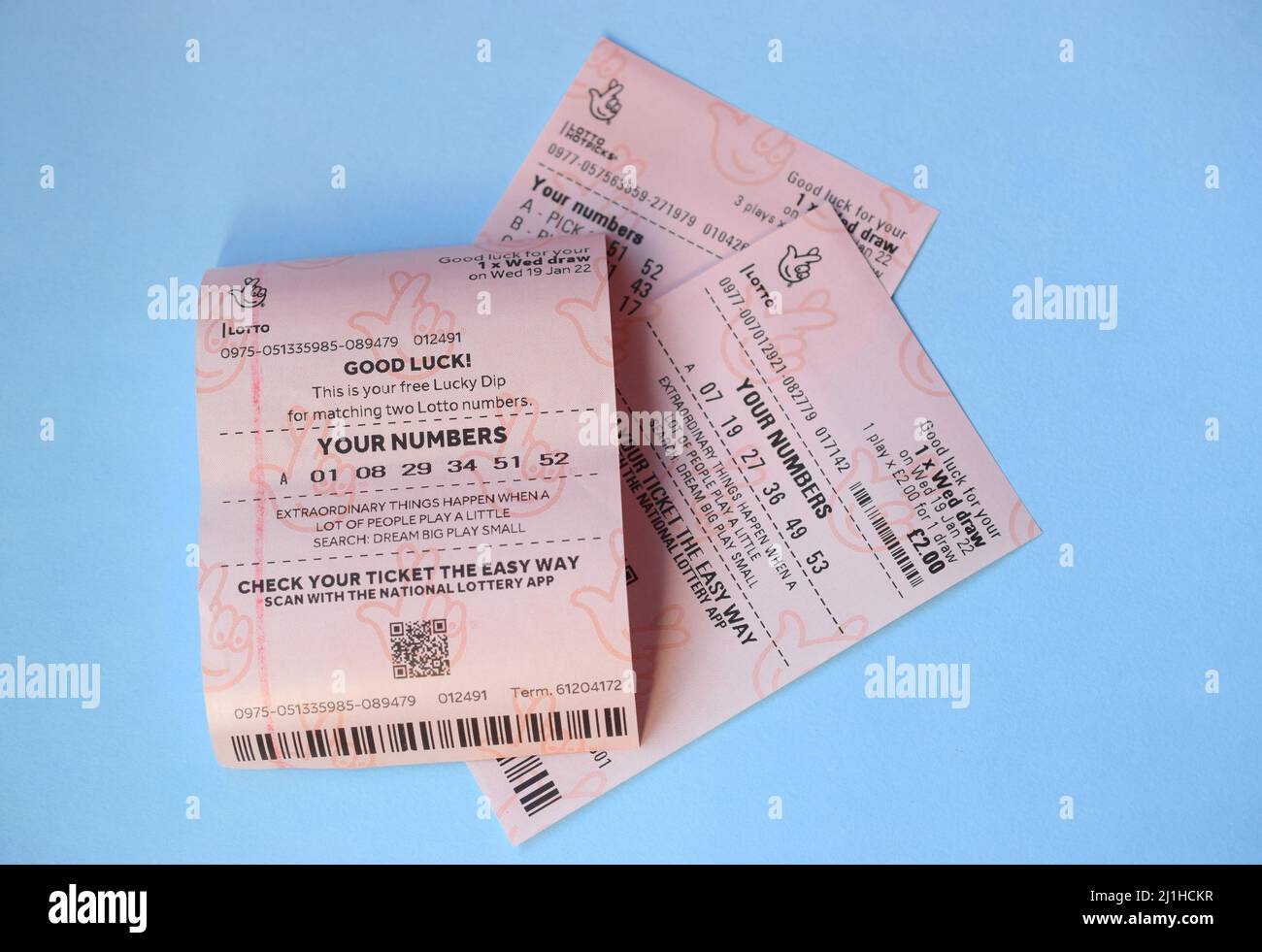British National lottery tickets on blue background. Stock Photo
