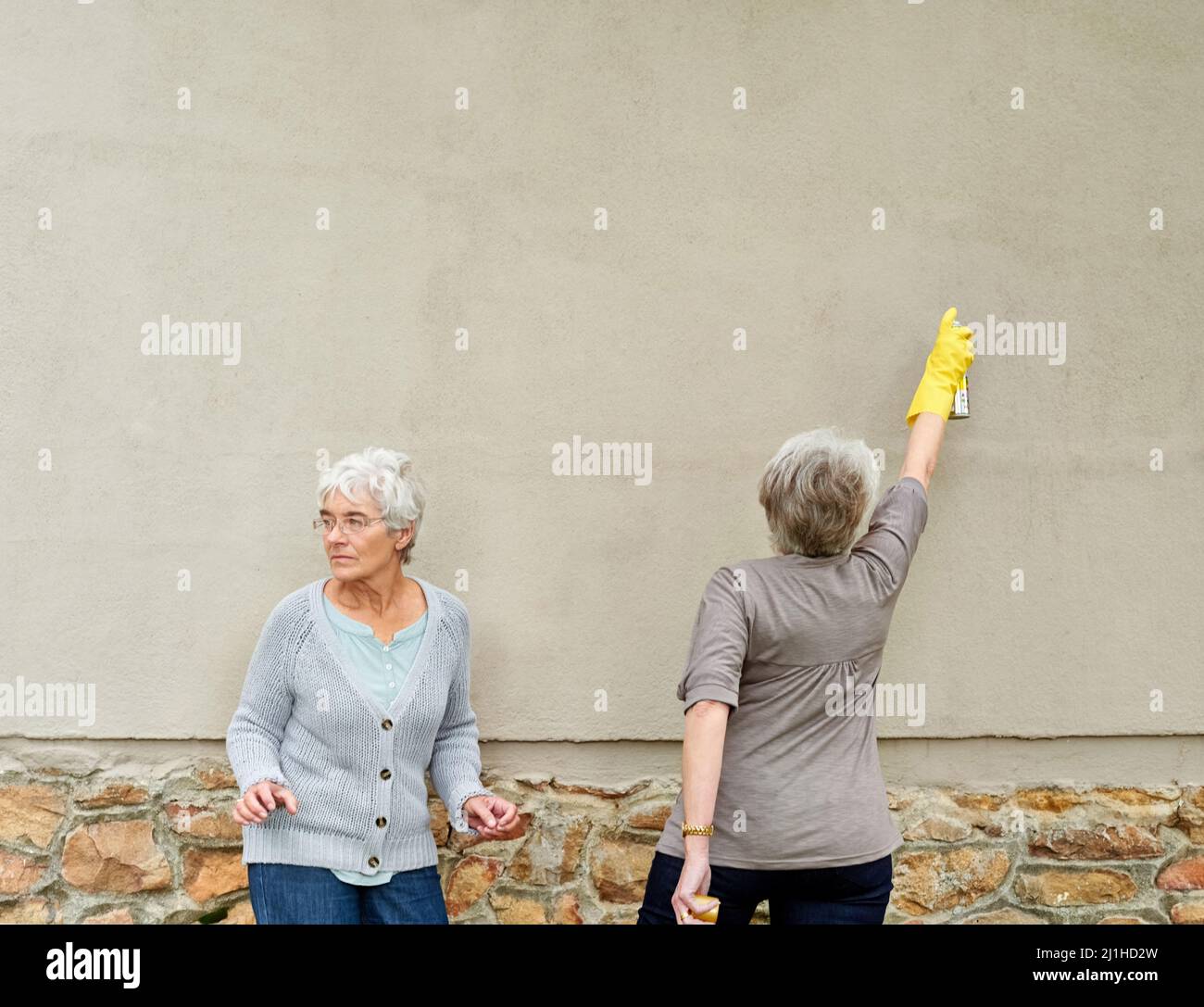 Woman holding spray painting hi-res stock photography and images - Alamy