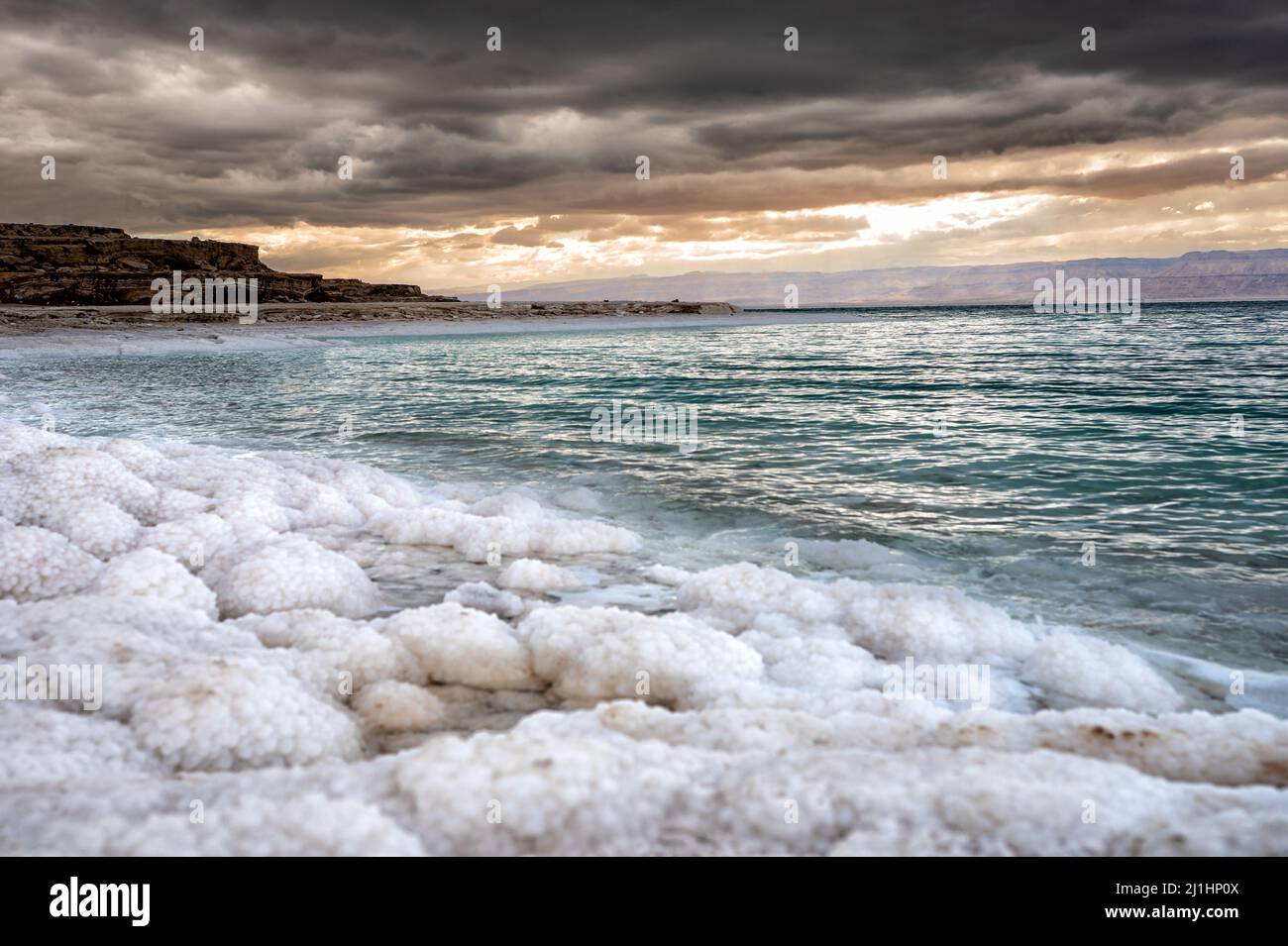 Salt beach of the Dead Sea at sunset, Jordan. Stock Photo