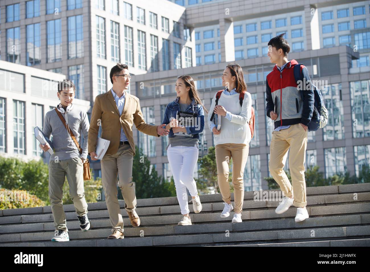 The teacher and the student walking and talking Stock Photo - Alamy