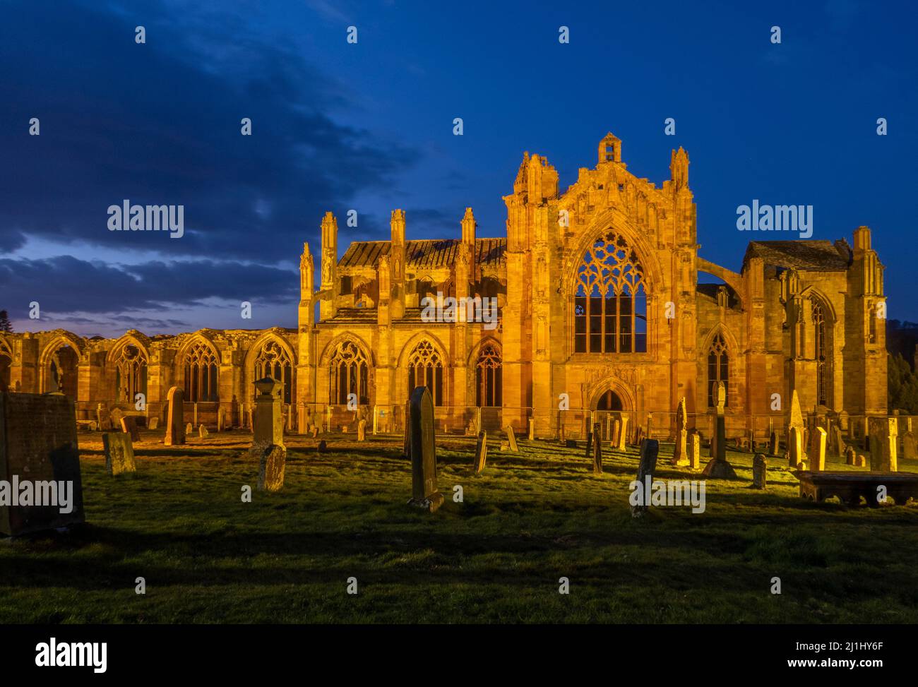 Scottish Borders, UK. 25th Mar, 2022. 25th March 2022 Scotland weather,  An evening view of the illuminated Melrose Abbey in the Scottish Borders.  David I founded Melrose Abbey, the first Cistercian monastery in Scotland, in 1136. It was one of a number of abbeys that he set up in the Borders to show both his piety and his power over this contested territory. Credit: phil wilkinson/Alamy Live News Stock Photo