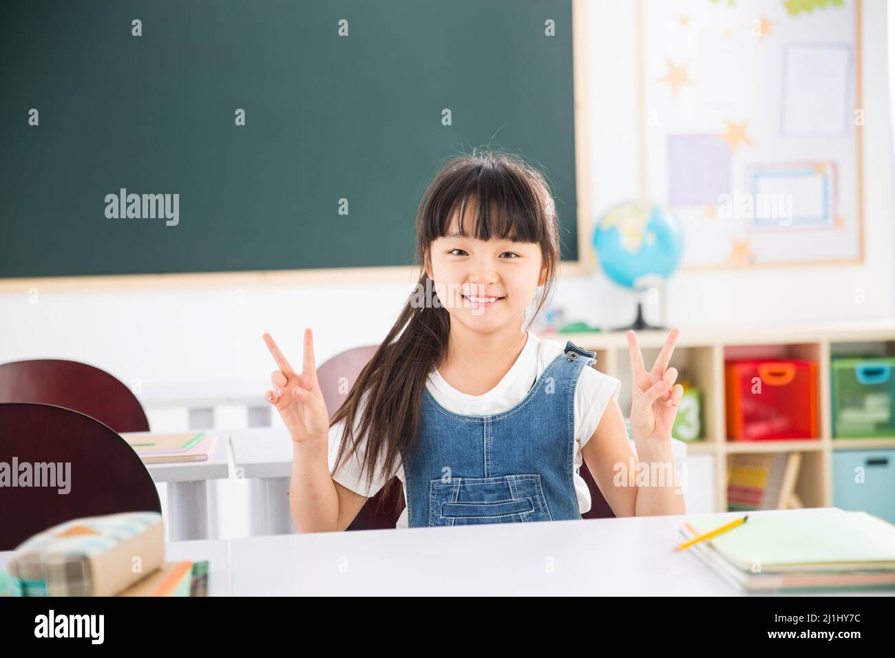 Primary school girls in the classroom Stock Photo - Alamy