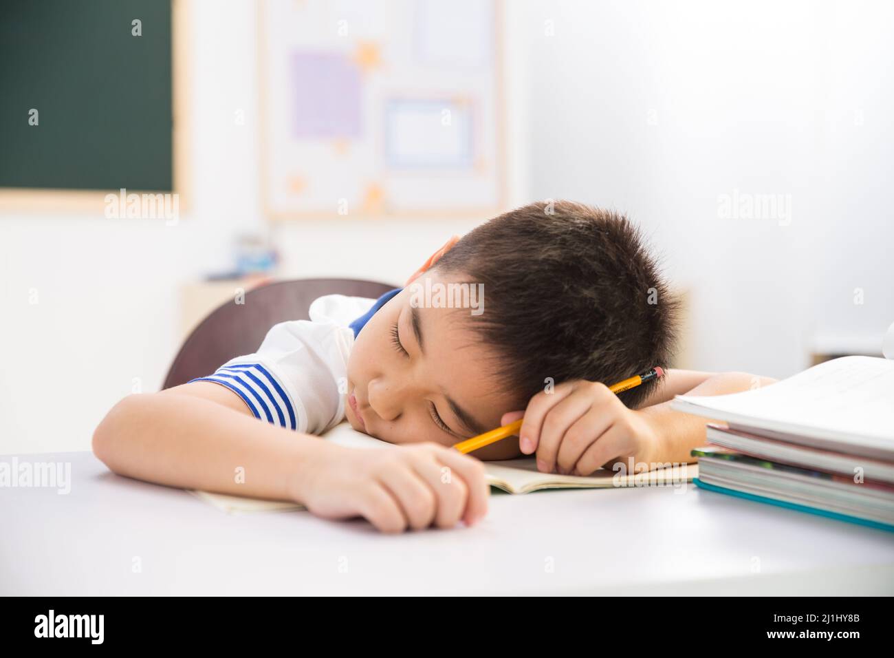 Primary School Boy In The Classroom Stock Photo - Alamy