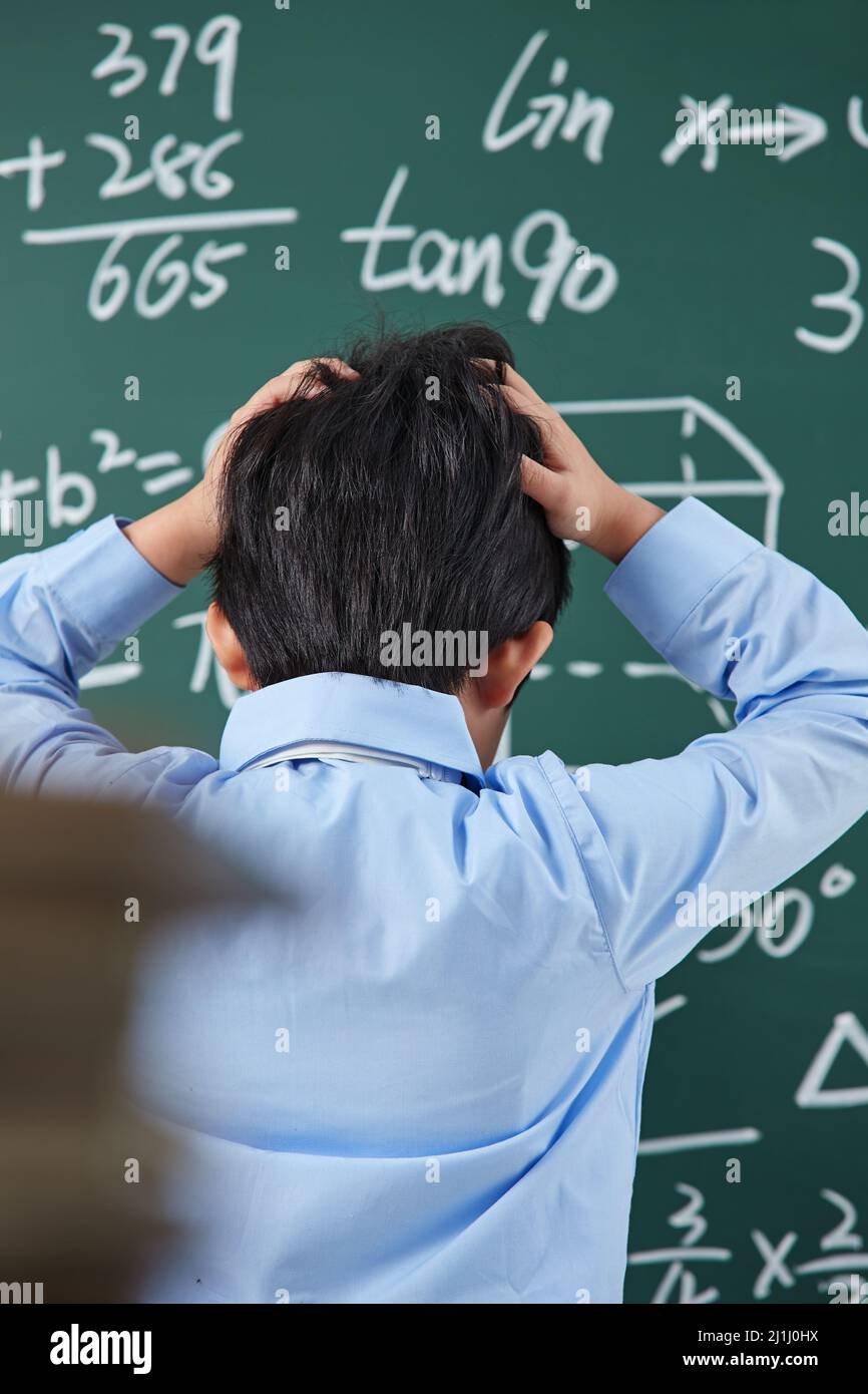 The back of elementary school boys were math problem difficult Stock ...