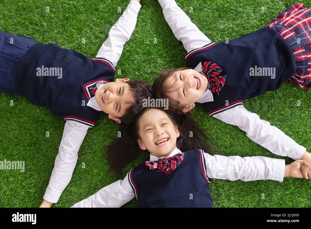The pupils lying on the grass Stock Photo