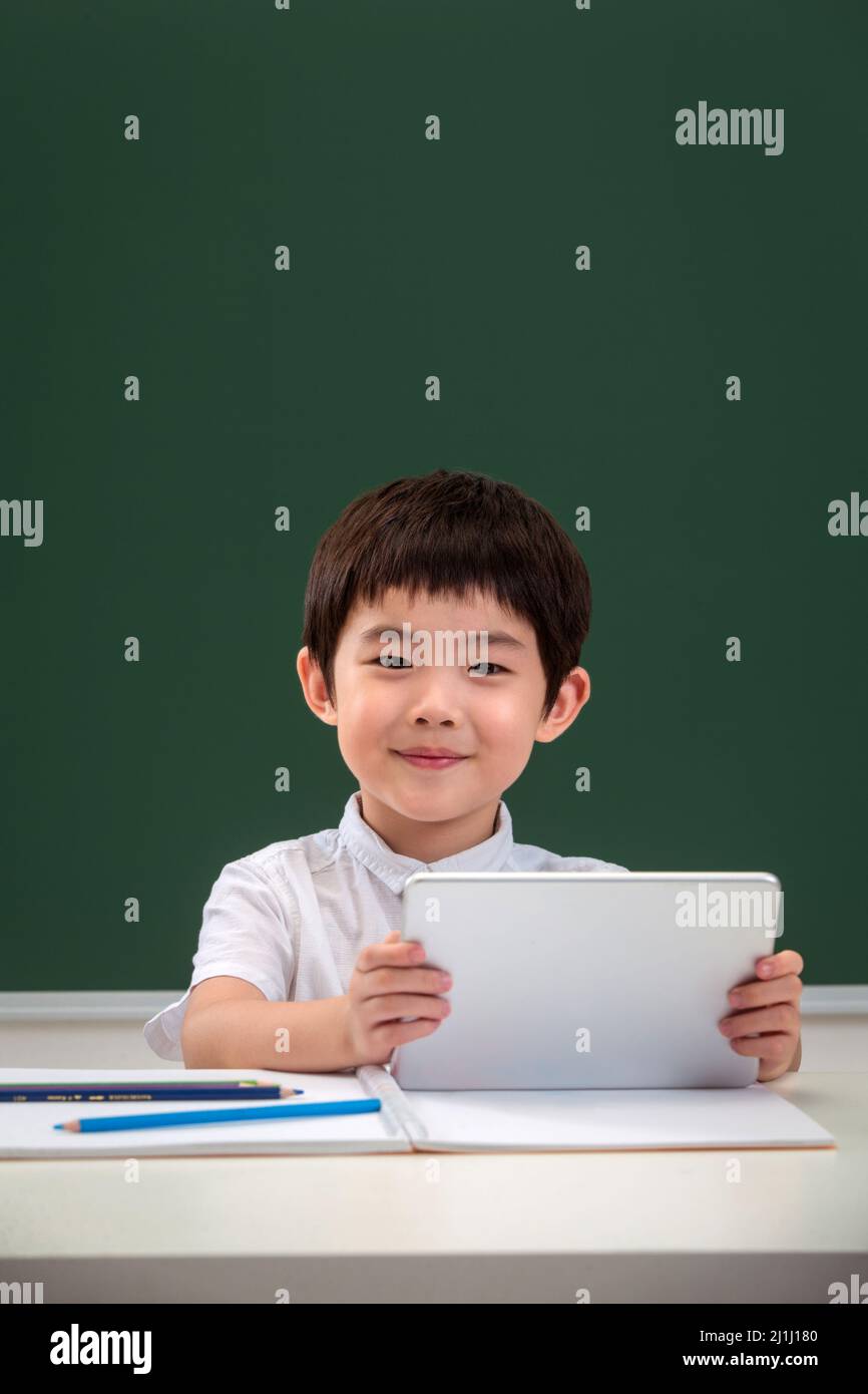 Elementary school students online learning Stock Photo