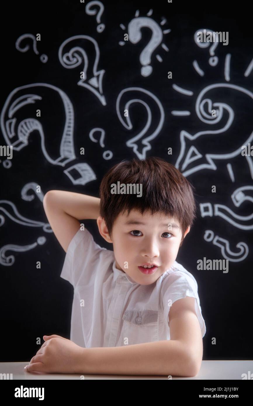 Primary school boy in thinking Stock Photo