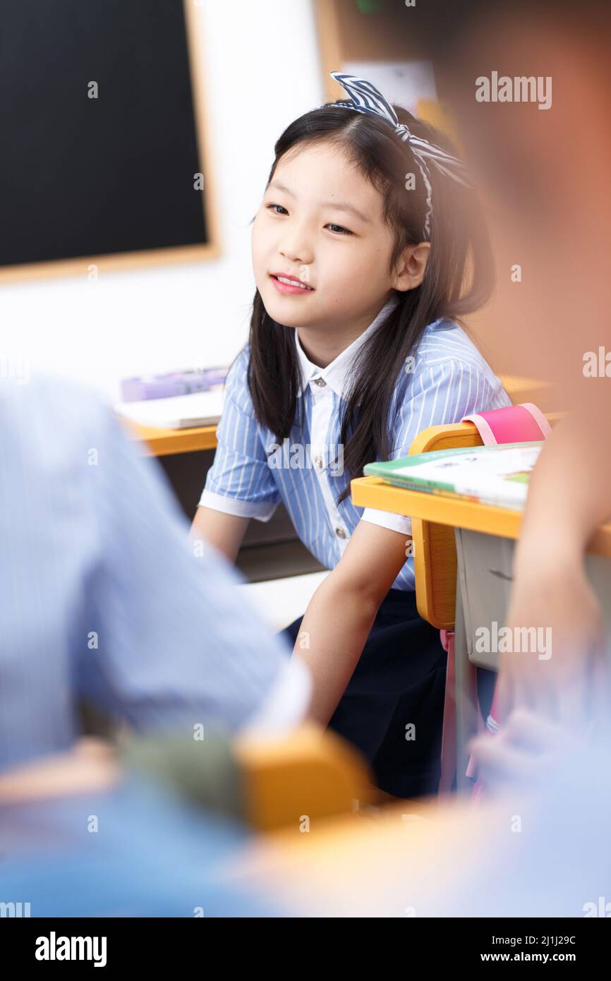 Primary school girls in the classroom Stock Photo - Alamy