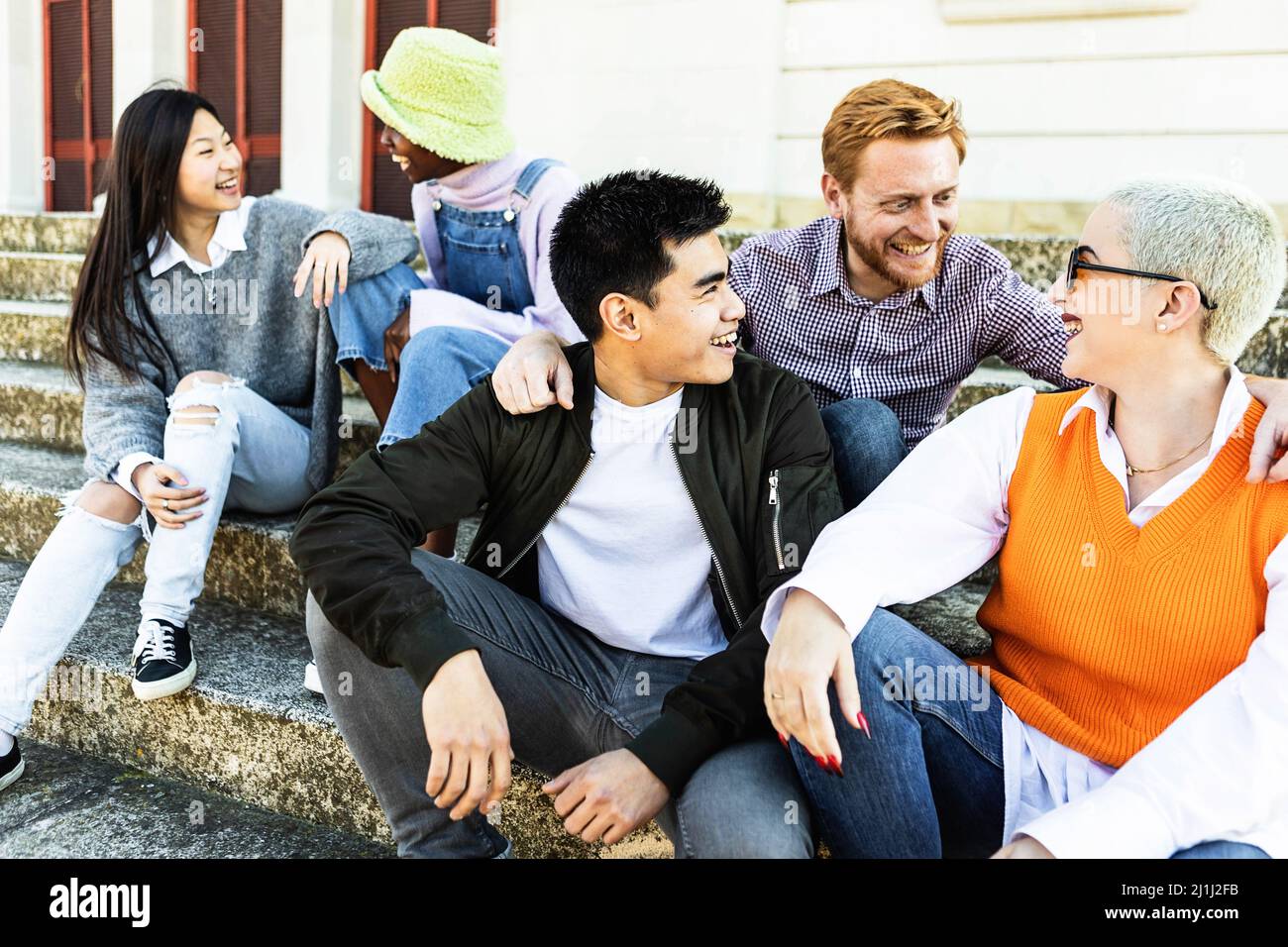 Trendy diverse millennial students laughing out loud and having fun together Stock Photo