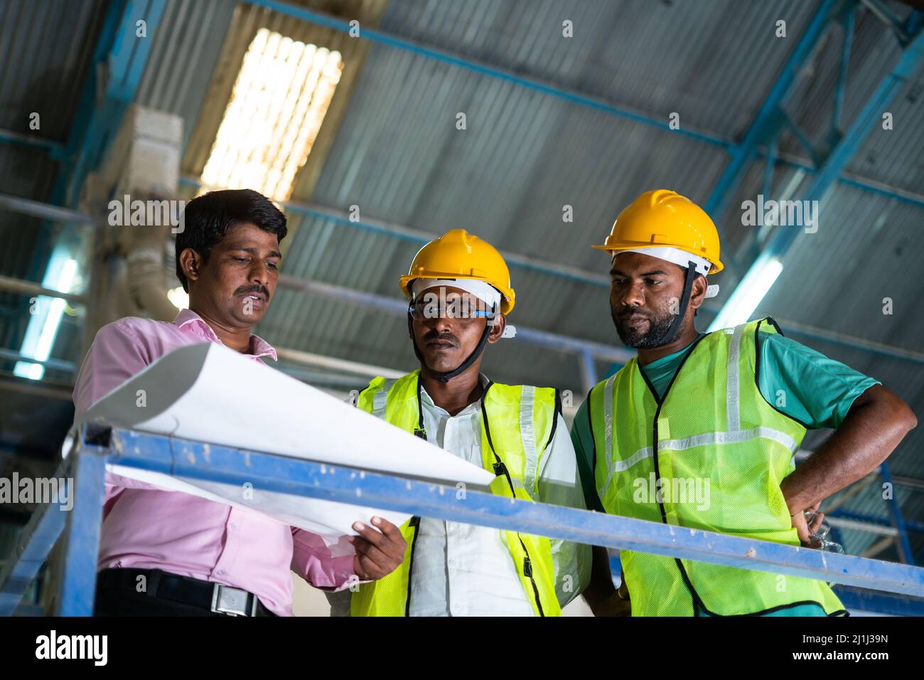 Industrial workers with planning engineer discussing about work at factory concept teamwork